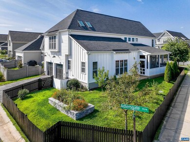 Fenced side yard with beautiful raised bed garden.