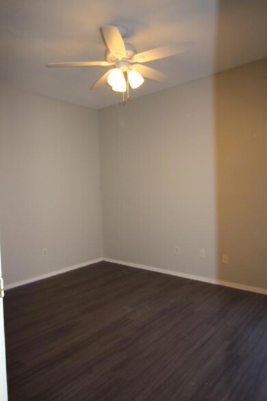 Spare room featuring baseboards, ceiling fan, and