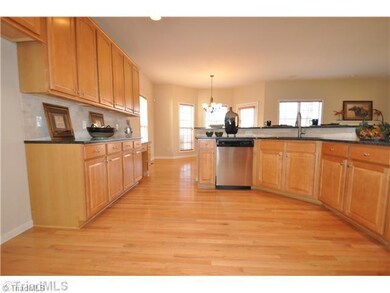 Kitchen. Kitchen features hardwood floors and NEW granite counters
