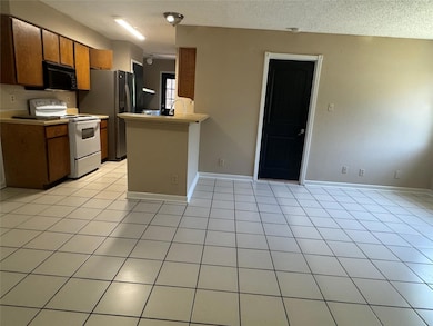 Kitchen featuring white electric stove, black mic