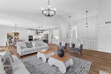 Living room with a chandelier, wood finished floors, high vaulted ceiling, and recessed lighting