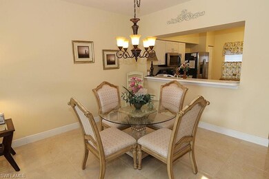 Tiled dining space with an inviting chandelier