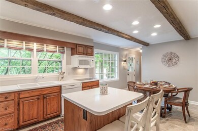 Kitchen has solid surface countertops with bar area for 