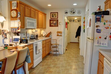 Kitchen with decorative light fixtures, light tile