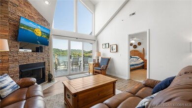 Large living room with lots of windows, natural li