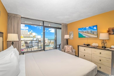Bedroom featuring a textured ceiling and access to outside