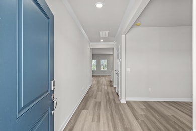 Hall with baseboards, ornamental molding, recessed