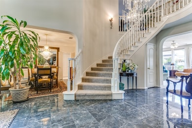 Dramatic curved staircase, tear drop crystal chand