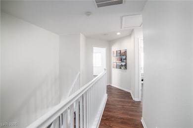 Hallway with dark wood finished floors, baseboards