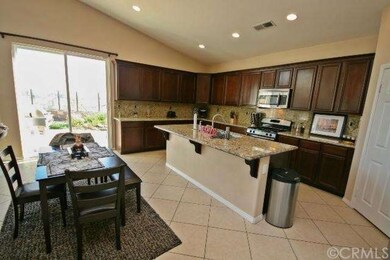 Large kitchen with island, upgraded flooring, cabi