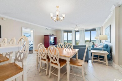Dining area featuring crown molding, light tile patterned floors, a ceiling fan, a textured ceiling, and a chandelier