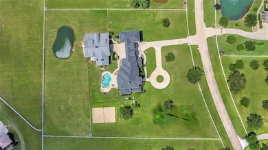 Aerial view of the property showing stocked pond t