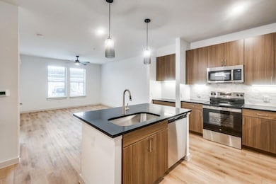 Kitchen with a sink, dark countertops, brown cabin