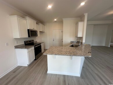 Kitchen featuring light stone countertops, stainle