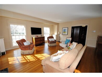 Spacious living room with crown and wall moldings,