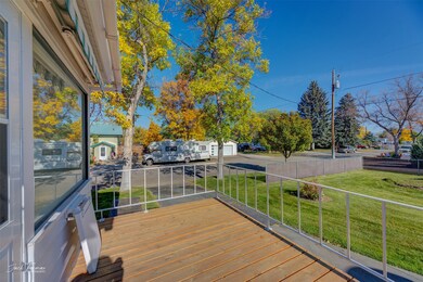 Wooden deck featuring a yard and a garage