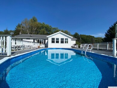 Inviting swimming pool in back yard w/surrounding 