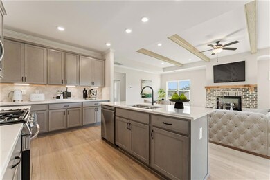 Kitchen with a kitchen island with sink, sink, a b