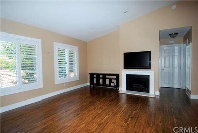 Large living room with newer paint, shutters, fire