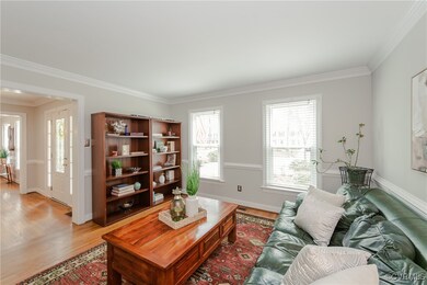 Living area with light wood-style floors, baseboar