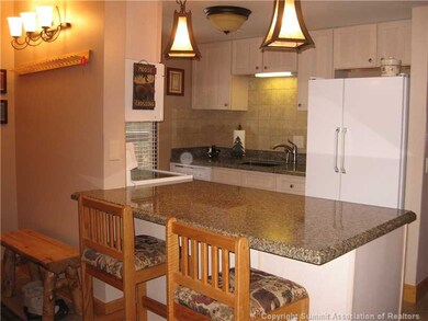 Kitchen. Nice breakfast  bar looking over the spac