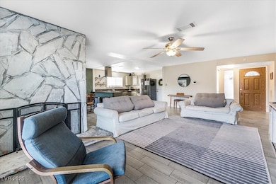 Living room featuring wood finished floors and ceiling fan