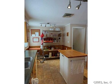 Kitchen. Open pantry shelving or a small table and