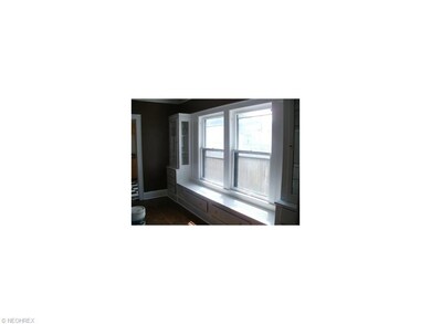 Upstairs dining room with new vinyl windows with window seat. Original built-ins on either side with leaded glass.