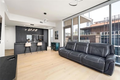 Living area featuring a notable chandelier, visib