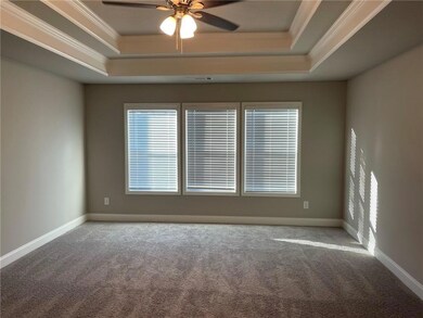 Carpeted spare room featuring baseboards, ceiling 