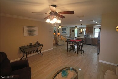 View of Living Room towards Dining Area, open Kitchen and Family room in background.
