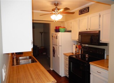 Galley kitchen with plenty of storage space and fu
