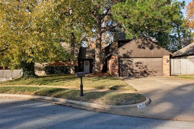 View of front of house with a front yard and a gar