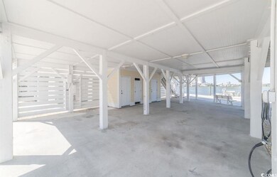 View of patio / terrace featuring a water view and a carport