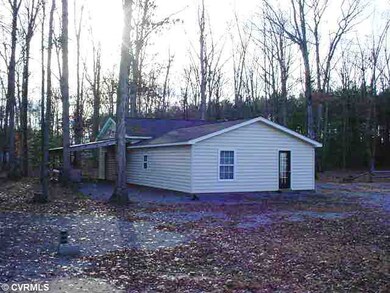 Exterior Front - BACK VIEW OF THE GARAGE WITH LEAN TO FOR OUTDOOR EQUIPMENT, ETC.