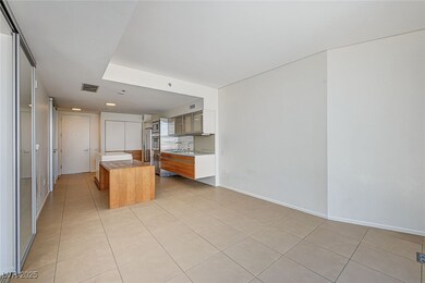 Kitchen with brown cabinets, light tile patterned floors, light countertops, and a center island
