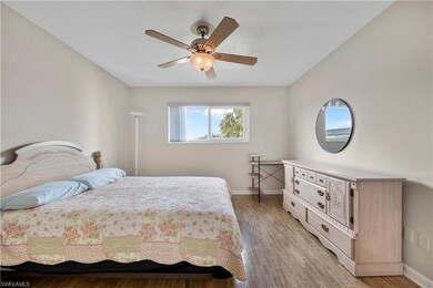 Bedroom featuring baseboards, ceiling fan, and lig