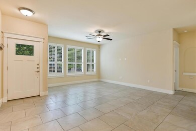 Foyer entrance featuring ceiling fan and light ti