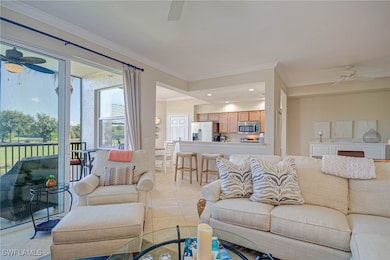 Living room with a ceiling fan, recessed lighting, ornamental molding, and light tile patterned floors