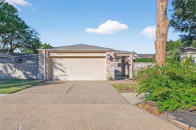 This inviting home features a charming brick exterior with a private gated entry, a spacious driveway, and a two-car garage that adds both convenience and curb appeal.
