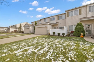 Traditional-style home with a residential view, driveway, and stone siding