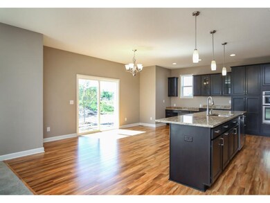 Open floorplan between kitchen, dining & family ro