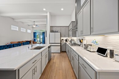 Kitchen with gray cabinetry, stainless steel appl