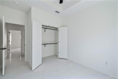 Unfurnished bedroom with light marble finish floors and a closet