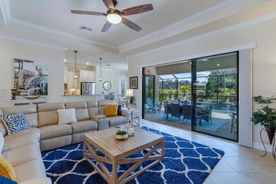 Living room with view into kitchen and lanai