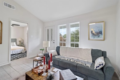 Living room featuring lofted ceiling and ceiling f