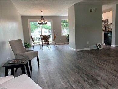 Vinyl plank flooring so easy to maintain & clean in the living room, dining room, & kitchen