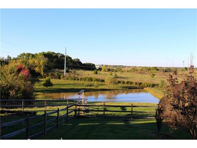Acreage & stocked pond behind the home are scenic 