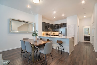 Main level dining space with dark wood floors and recessed lighting