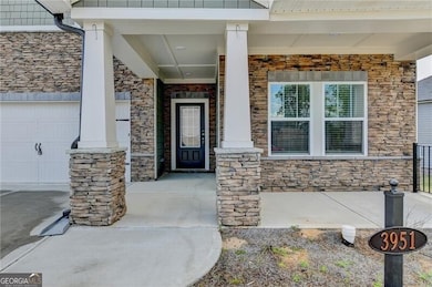 Entrance to property with a garage, a porch, and s